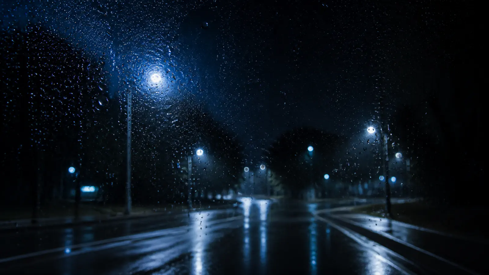 Rain on a windscreen at night.