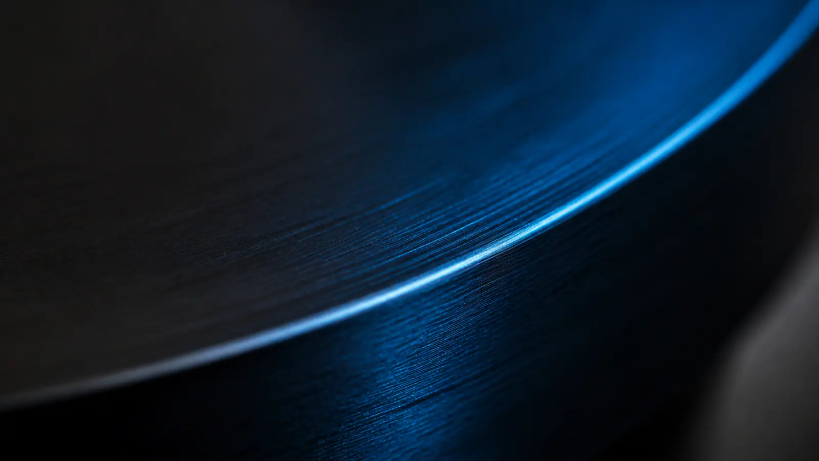 Light raking across a machined metal edge.