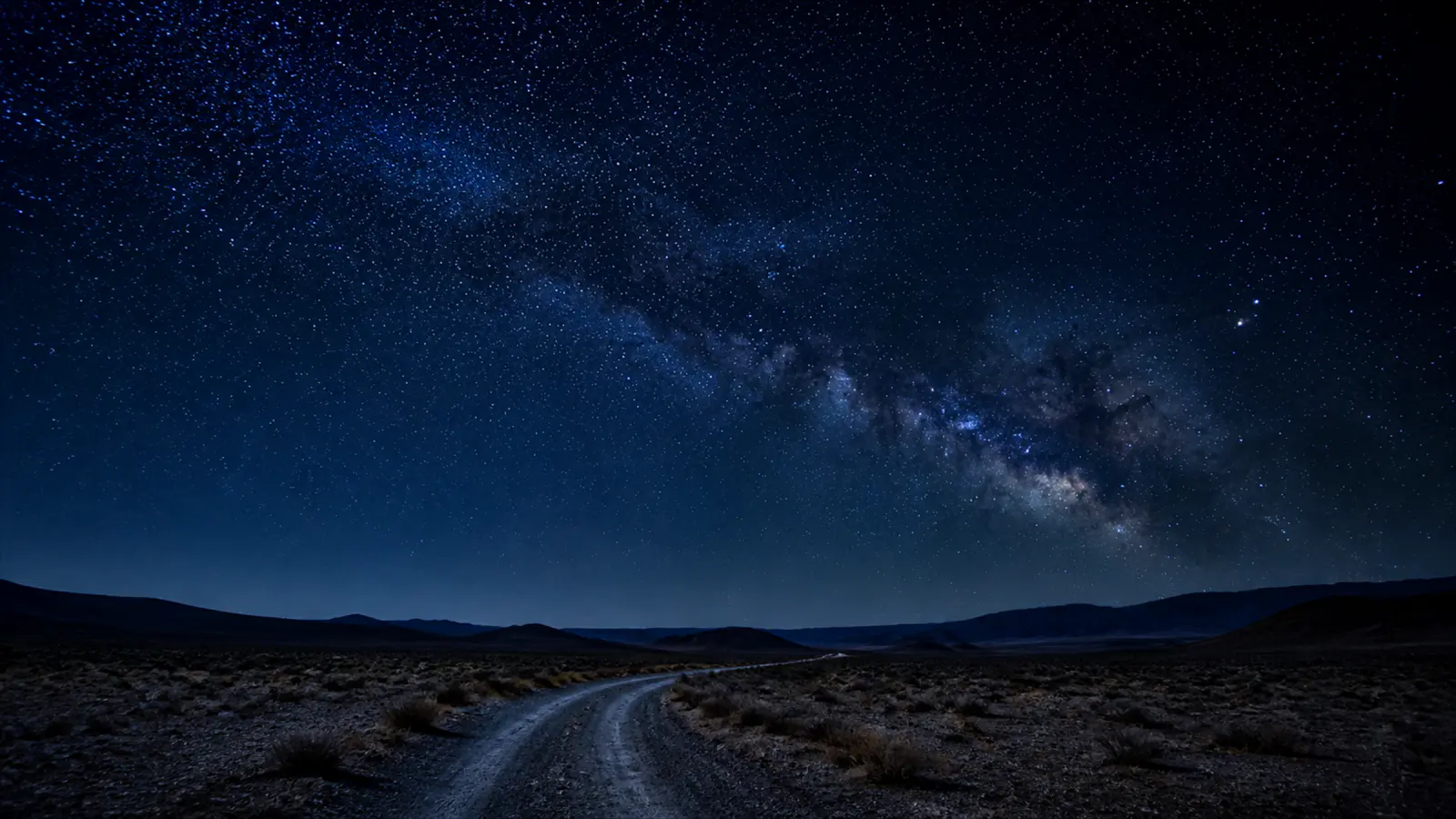 A remote track running to the horizon at night.